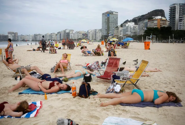 Tourists rest on Copacabana beach in Rio de Janeiro, Brazil, May 5, 2016. (Photo by Nacho Doce/Reuters)