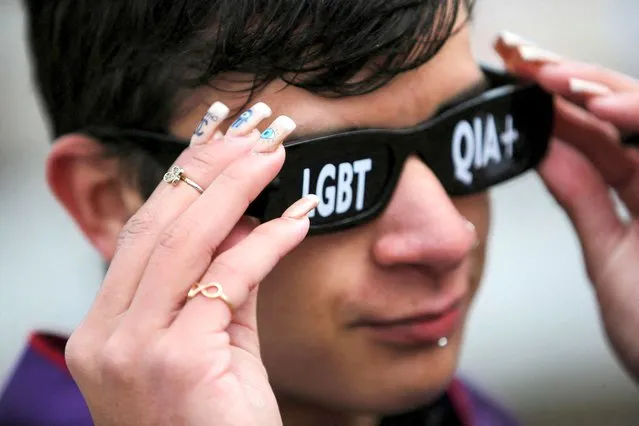 A reveller wears themed sunglasses during the LGBTIQ 'Fight Parade' in Porto Alegre, state of Rio Grande do Sul, Brazil on July 17, 2022. (Photo by Diego Vara/Reuters)