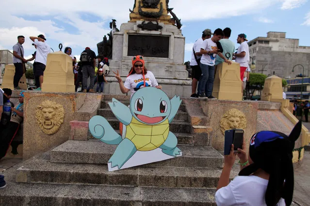 Fans of the augmented reality mobile game “Pokemon Go” by Nintendo participate in a “poketour” organized by the municipality in San Salvador, El Salvador July 23, 2016. (Photo by Jose Cabezas/Reuters)