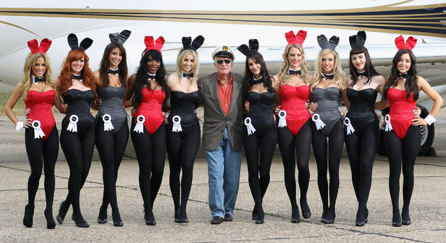 Playboy founder Hugh Hefner (centre) arrives at Stansted Airport on June 2, 2011 in Stansted, England. The photograph is a recreation of a picture originally taken in the 1960's, with ten of the new London Bunnies. Mr Hefner is back in the UK to mark the launch of the new Playboy Club in Mayfair, which opens on June 4. The clubs opening will welcome back the iconic Playboy Bunny to Londonafter a 30 year absence. Famous Bunnies have included Debbie Harry and Lauren Hutton. (Photo by Dan Kitwood/Getty Images)