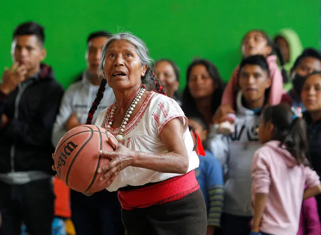 Andrea Garcia Lopez, 71, nicknamed “Granny Jordan” by TikTok users, plays basketball during an exhibition game in San Esteban Atatlahuca, Oaxaca, Mexico on August 3, 2022. (Photo by Jorge Luis Plata/Reuters)