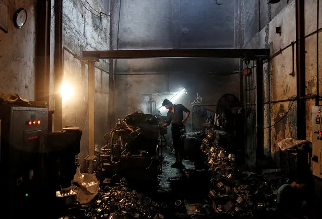 A worker makes parts for household mixers inside a small-scale manufacturing unit in Mumbai, India, August 1, 2016. (Photo by Danish Siddiqui/Reuters)