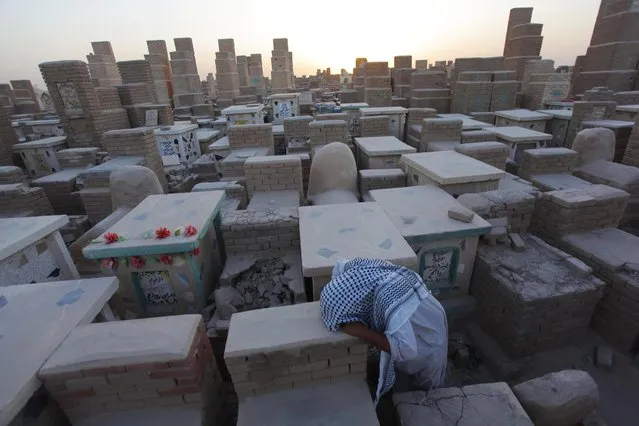 A man grieves at a cemetery in Najaf, south of Baghdad September 15, 2014. (Photo by Alaa Al-Marjani/Reuters)