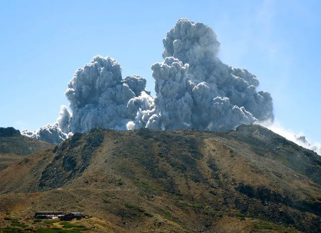 In this photo taken by an anonymous climber and was offered to Kyodo News, dense plumes rise from the summit crater of Mt. Ontake shortly after the volcanic mountain erupts in central Japan, Saturday, September 27, 2014. (Photo by AP Photo/Kyodo News)