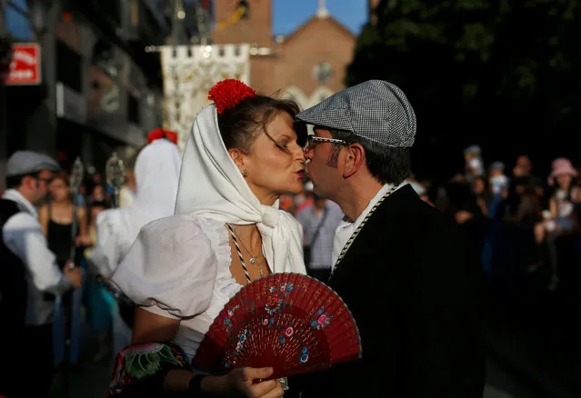 People dressed in Madrid's traditional attire “Chulapos” attend the Feast of La Paloma Virgin in Madrid, Spain, August 15, 2016. (Photo by Javier Barbancho/Reuters)