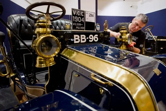Bonhams employee Craig Binns polishes a 1904 Wilson-Pilcher, thought to be the oldest surviving example of its type on November 1, 2012 in London, England. The Car is part of a Veteran Car Sale at Bonhams and is valued at around 220,000 pounds  (Photo by Bethany Clarke)