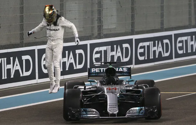 Mercedes driver Lewis Hamilton of Britain celebrates after the Emirates Formula One Grand Prix at the Yas Marina racetrack in Abu Dhabi, United Arab Emirates, Sunday, November 26, 2017. (Photo by Luca Bruno/AP Photo)
