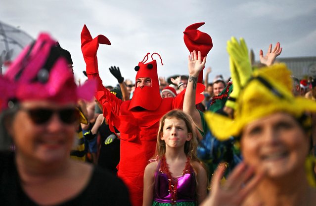 People take part in the annual New Year's Day Dip, on the beach in Ramsgate, south east England on January 1, 2024. (Photo by Ben Stansall/AFP Photo)