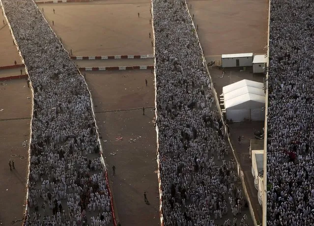 Muslim pilgrims walk on roads as they head to cast stones at pillars symbolizing Satan during the annual haj pilgrimage in Mina on the first day of Eid al-Adha, near the holy city of Mecca September 24, 2015. (Photo by Ahmad Masood/Reuters)