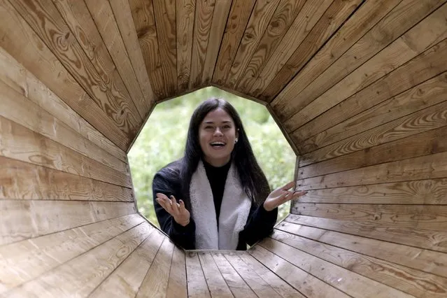 Interior architecture student Birgit Oigus poses for a picture in the wooden megaphone in the forest near Pahni village, Estonia, September 28, 2015. (Photo by Ints Kalnins/Reuters)