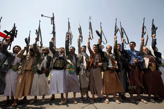 Armed men loyal to the Houthi movement wave their weapons as they gather to protest against the Saudi-backed exiled government deciding to cut off the Yemeni central bank from the outside world, in the capital Sanaa, Yemen August 25, 2016. (Photo by Mohamed al-Sayaghi/Reuters)