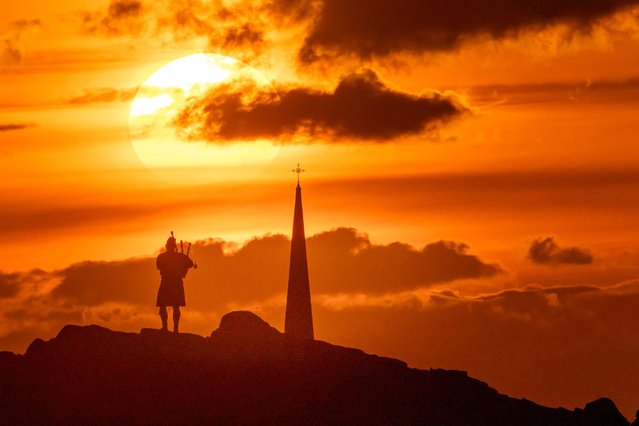 Andrew Robertson, a piper, playing at sunset in the second decade of April 2025 standing on Salisbury Crags above Edinburgh, while his girlfriend Tierney Reid waits out of shot nearby to propose to him. (Photo by Tom Duffin/Solent News)