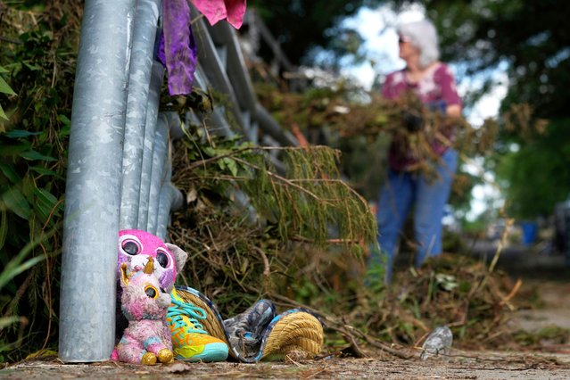 Lost items sit at a bridge as a volunteer cleans up debris on Tuesday, July 8, 2025, after a flash flood swept through the area in Kerrville, Texas. (Photo by Ashley Landis/AP Photo)