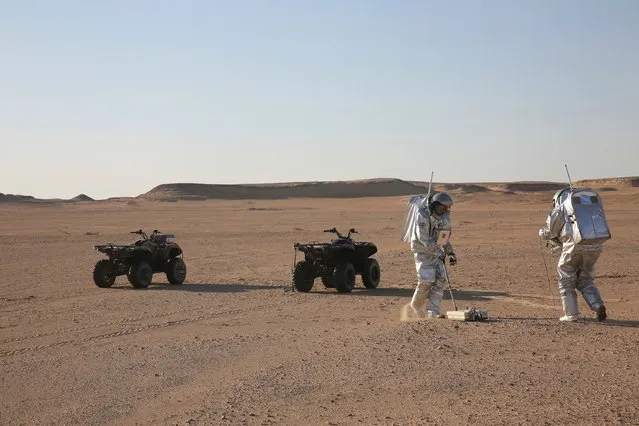 In this February 7, 2018, photo, two scientists test space suits and a geo-radar for use in a future Mars mission in the Dhofar desert of southern Oman. (Photo by Sam McNeil/AP Photo)
