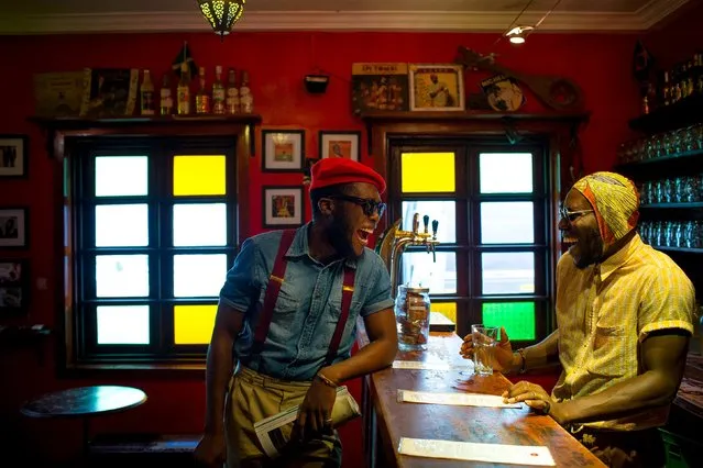 DJ Evans Mireku Kissi (R) and stylist Daniel Quist share a laugh at the Republic Bar in Accra, Ghana, June 10, 2015. (Photo by Francis Kokoroko/Reuters)