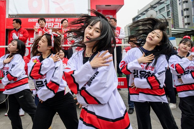 South Korea's ruling People Power Party campaigners dance during a party rally ahead of the upcoming parliamentary elections in Seoul on April 8, 2024. (Photo by Anthony Wallace/AFP Photo)