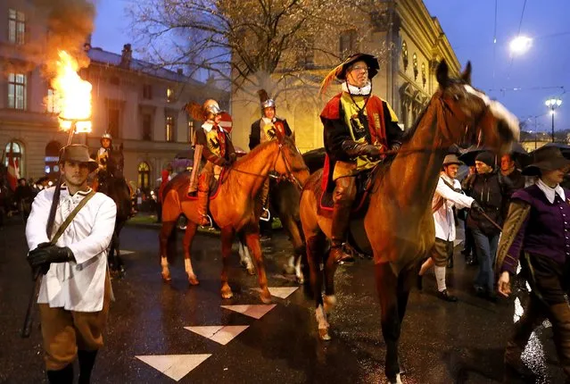 Members of the Compagnie 1602 take part in a procession in Geneva December 14, 2014. (Photo by Pierre Albouy/Reuters)