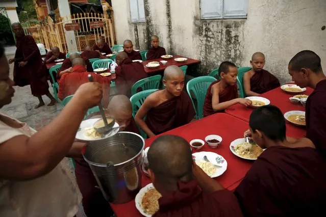 Buddhist monks eat breakfast outside a monastery in Mandalay October 7, 2015. (Photo by Jorge Silva/Reuters)