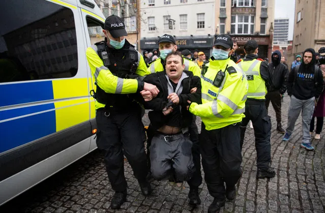 Police arrest a man during the anti-lockdown protest on November 14, 2020 in Bristol, England. (Photo by Matthew Horwood/Getty Images)
