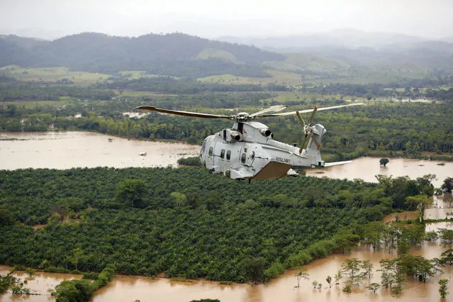 In this undated handout photo provided by the Ministry of Defence on Saturday, November 21, 2020, a Merlin Helicopter from 845 Naval Air Squadron conducting damage surveys in Honduras. The devastation caused by Hurricane Iota is becoming clear as communications are restored after the second Category 4 hurricane in two weeks to blast Nicaragua’s Caribbean coast. The official death toll rose in Nicaragua with victims swept away by swollen rivers or buried in landslides. (Photo by LPhot Robert Oates/Ministry of Defence via AP Photo)