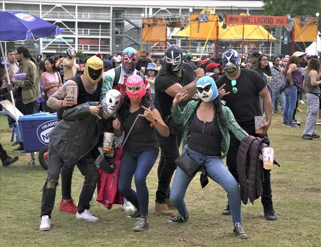 Fans of Mexican surf garage band Lost Acapulco pose for a photo during the Vive Latino music festival in Mexico City, Sunday, March 19, 2023. (Photo by Fernando Llano/AP Photo)