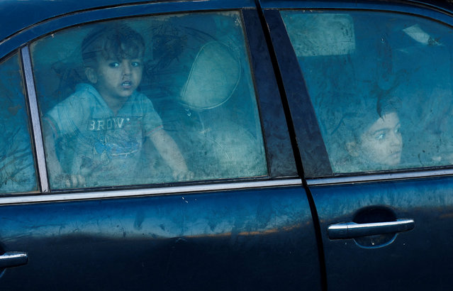Displaced Palestinians, who fled northern Gaza after Israeli forces ordered residents of Gaza City to evacuate to the south amid an Israeli military operation, sit inside a car that broke down, in the central Gaza Strip, on October 3, 2025. (Photo by Mahmoud Issa/Reuters)