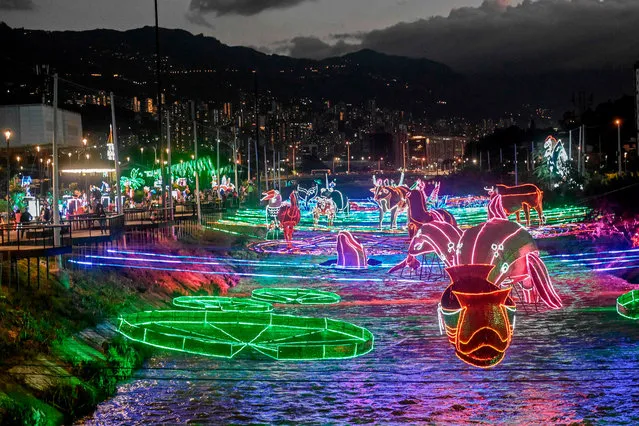 View of Christmas illuminated decorations over the Medellin river in Medellin, Colombia on December 3, 2020. (Photo by Joaquín Sarmiento/AFP Photo)