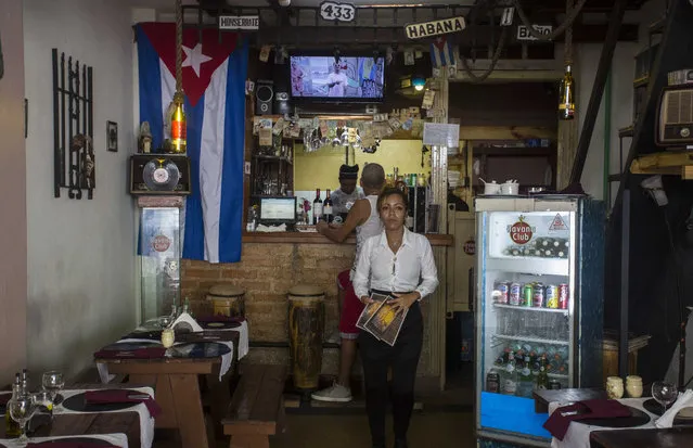 A waitress at a private restaurant waits for customers in Havana, Cuba, Tuesday, October 3, 2017. (Photo by Desmond Boylan/AP Photo)