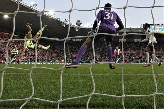 Manchester City's Erling Haaland, second from left, scores his side's third goal past Southampton's goalkeeper Gavin Bazunu during the English Premier League soccer match between Southampton and Manchester City at St Mary's Stadium in Southampton, England, Saturday, April 8, 2023. (Photo by Frank Augstein/AP Photo)