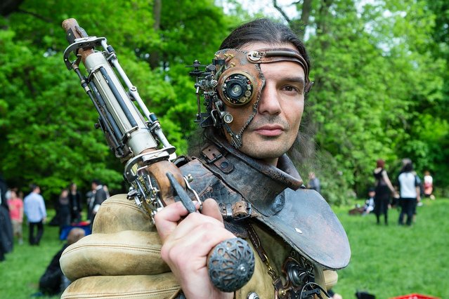 A man dressed as a steam-punk attends the traditional park picnic on the first day of the annual Wave-Gotik Treffen, or Wave and Goth Festival, on May 17, 2013 in Leipzig, Germany. The four-day festival, in which elaborate fashion is a must, brings together over 20,000 Wave, Goth and steam punk enthusiasts from all over the world for concerts, readings, films, a Middle Ages market and workshops. (Photo by Marco Prosch)