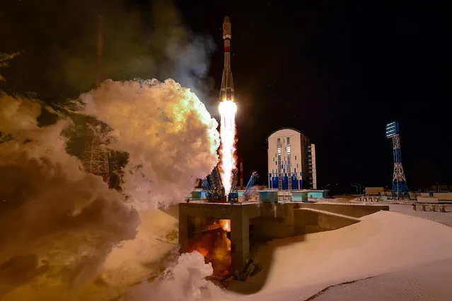 A Soyuz-2.1b rocket booster carrying the satellites of British firm OneWeb blasts off from a launch pad at the Vostochny Cosmodrome in Amur Region, Russia on December 18, 2020. (Photo by Russian space agency Roscosmos/Handout via Reuters)