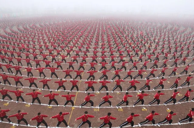 Students perform during a founding ceremony of a football team of Shaolin Tagou martial arts school, in Dengfeng, Henan province, November 10, 2015. (Photo by Reuters/China Daily)