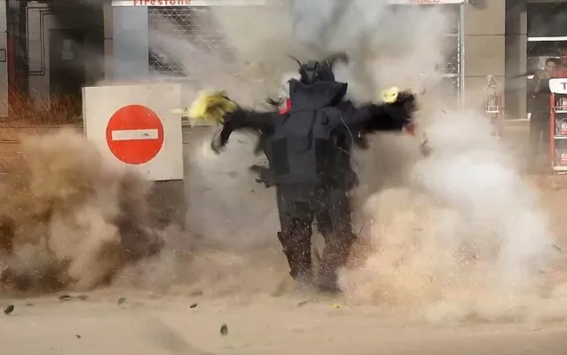 This still image grab taken from a video on January 6, 2015 by the Al-Youm al-Saabi newspaper, shows an Egyptian police officer being blown up as the bomb he was trying to defuse detonated outside a petrol station in Cairo. The officer was killed while trying to defuse a bomb, police said, with jihadists claiming responsibility. (Photo by AFP Photo/Al-Youm Al-Saabi Newspaper)