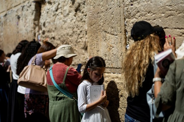 A Jewish girl prays at the Western Wall, Judaism's holiest prayer site, in the Old City of Jerusalem on July 1, 2024. (Photo by Eloisa Lopez/Reuters)
