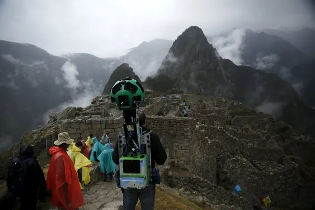 An operator walks carrying the Trekker, a 15-camera device, while mapping the Inca citadel of Machu Picchu for Google Street View in Cuzco, Peru, August 11, 2015. (Photo by Pilar Olivares/Reuters)