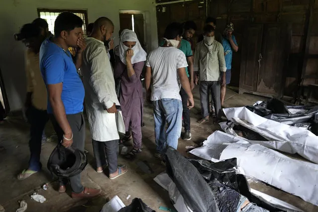People try to identify their relatives who was traveling in the train that derailed in Balasore district, in the eastern Indian state of Orissa, Sunday, June 4, 2023. (Photo by Rafiq Maqbool/AP Photo)