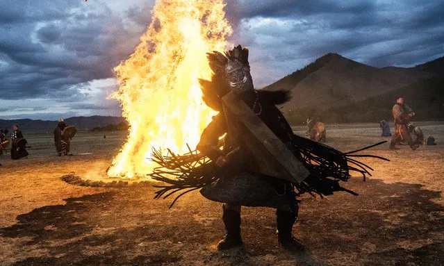 Mongolian Shamans or Buu, take part in a fire ritual meant to summon spirits to mark the period of the Summer Solstice in the grasslands on June 22, 2018 outside Ulaanbaatar, Mongolia. (Photo by Kevin Frayer/Getty Images)
