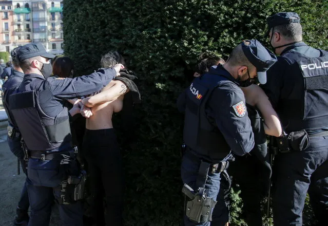 Police officers detain Femen activists during a demonstration of supporters of former Spanish dictator Francisco Franco, during annual gathering held on the week of the 45th anniversary of the dictator's death, in Madrid, Spain, November 22, 2020. (Photo by Javier Barbancho/Reuters)