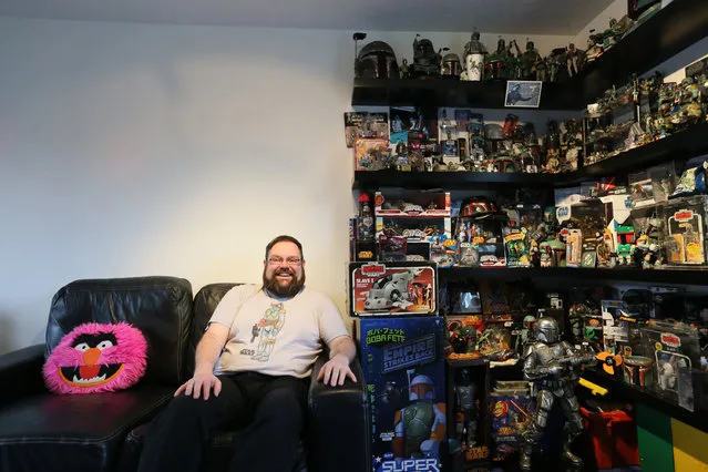 Star Wars collector Matt Booker, 38, poses for a photograph next to some of his Boba Fett collection at his home in Corsham, Wiltshire November 24, 2015. Matt said he has a collection of over 8,000 Boba Fett pieces. (Photo by Paul Hackett/Reuters)