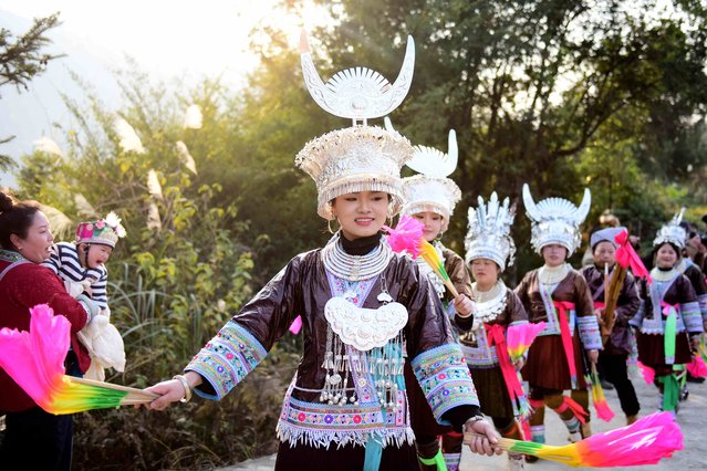 This photo taken on January 4, 2025 shows people from the Miao ethnic group attending a cultural new year celebration as part of the Lu Sheng (traditional wind instrument) festival in Congjiang county, Qiandongnan Miao and Dong Autonomous Prefecture, in southwestern China's Guizhou province. (Photo by AFP Photo/China Stringer Network)