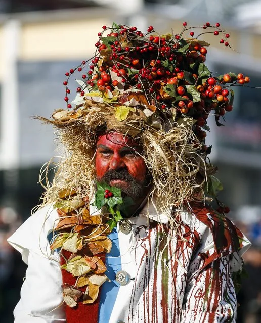 A man with a painted face and traditional costumes takes part in the Schleicherlaufen festival in the western Austrian town of Telfs February 1, 2015. (Photo by Dominic Ebenbichler/Reuters)