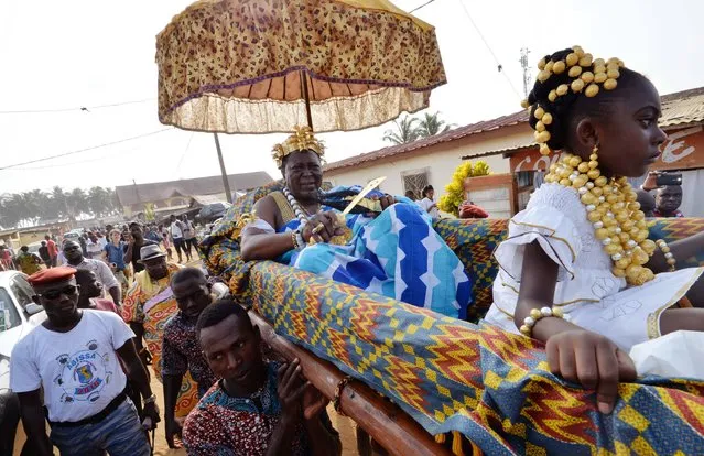 Desire Amon Tanoe, the King of the N'Zima Kotoko and President of the Directory of the Chamber of Kings and traditional leaders of Ivory Coast, is carried in a palanquin on November 20, 2016 in the France neighborhood of the seaside resort of Grand-Bassam, to mark the annual traditional feast of the N'Zima people, the Abissa feast.
The king parades to convey messages of peace and cohesion. The N'Zima live in Ivory Coast and Ghana. (Photo by Sia Kambou/AFP Photo)