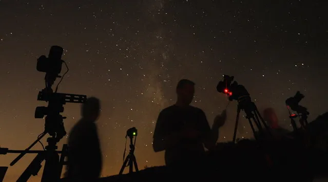 (L-R) Los Angeles photographers Shawn Kaye, Scott Meadows and Steve Gentry set their cameras pointed to the stars during the Perseid meteor shower early on Monday morning north of Castaic Lake, California August 12, 2013. (Photo by Gene Blevins/Reuters)