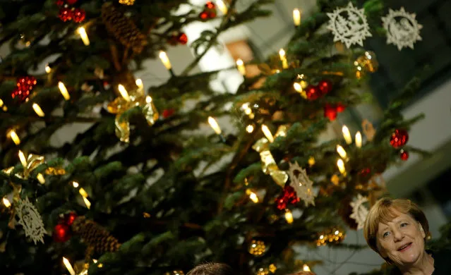 German Chancellor Angela Merkel receives this year's Christmas tree during a ceremony in the foyer of the Chancellery in Berlin, Germany, November 23, 2016. (Photo by Fabrizio Bensch/Reuters)