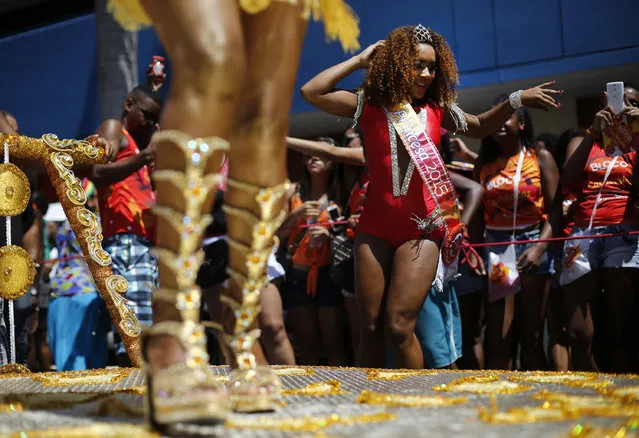 Dancers perform in a street party promoting black pride and  encouraging Afro-Brazilian women to flaunt their curls in Rio de Janeiro, Brazil, Sunday, February 8, 2015. (Photo by Silvia Izquierdo/AP Photo)