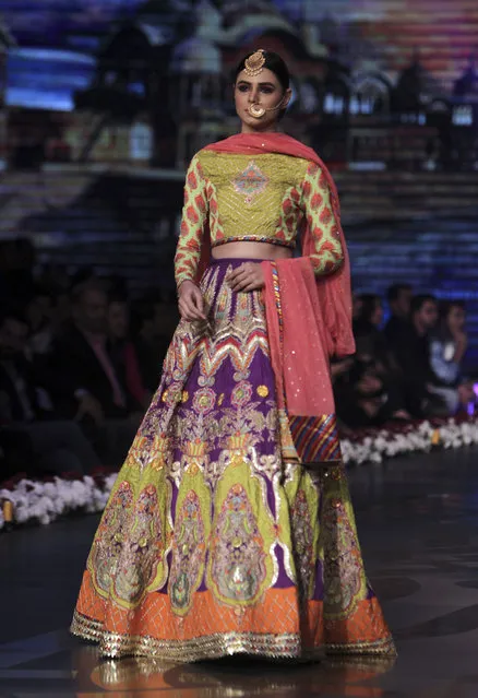 A model presents a bridal creation by designer Wardha Saleem during Bridal Couture Week 2016 in Lahore, Pakistan, Sunday, November 27, 2016. (Photo by K.M. Chaudary/AP Photo)
