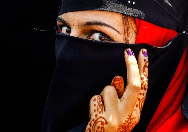 A member of a Kashmiri women's separatist group, attends a protest against recent riots, in Srinagar, on August 12, 2013. Three people died in riots between Hindus and Muslims over the weekend. (Photo by Danish Ismail/Reuters)