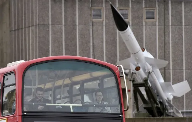 A bus passes a surface-to-air missile mounted on top of the Hayward Gallery, at Southbank in central London, February 7, 2015. The six-tonne Bloodhound missile has been preserved, restored and now shown by British artist Richard Wentworth in the Cold War section of “History is Now”, an exhibition on Britain since the Second World War. (Photo by Toby Melville/Reuters)