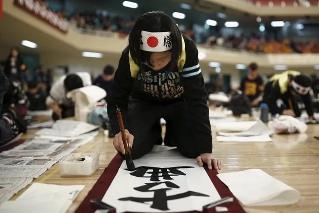 A girl participates in a calligraphy contest to celebrate the New Year in Tokyo January 5, 2016. The characters read: "the classics". (Photo by Thomas Peter/Reuters)