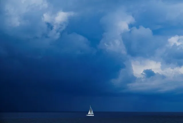 A yacht sails by as a storm approaches from out at sea in Pembroke, Malta on April 9, 2023. (Photo by /Darrin Zammit Lup/Reuters)